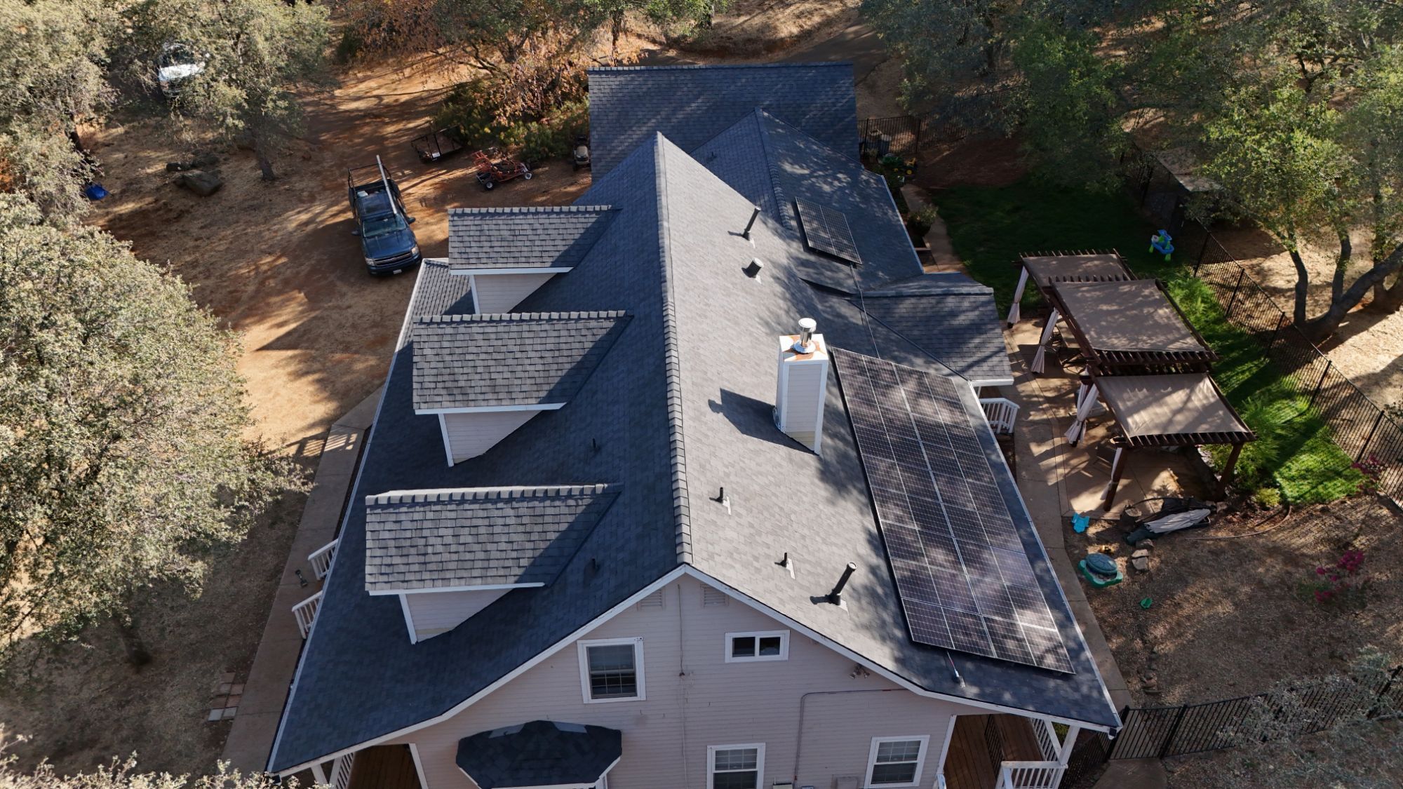 Aerial view down the ridge of the new Landmark Solaris roof with rooftop solar panels in Cameron Park