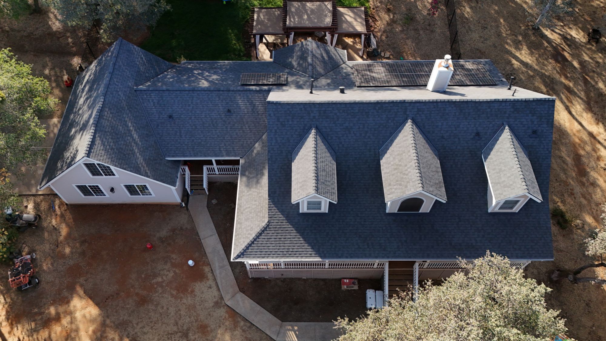 Overhead view of the new Moire Black roof with three dormers on a Cameron Park home