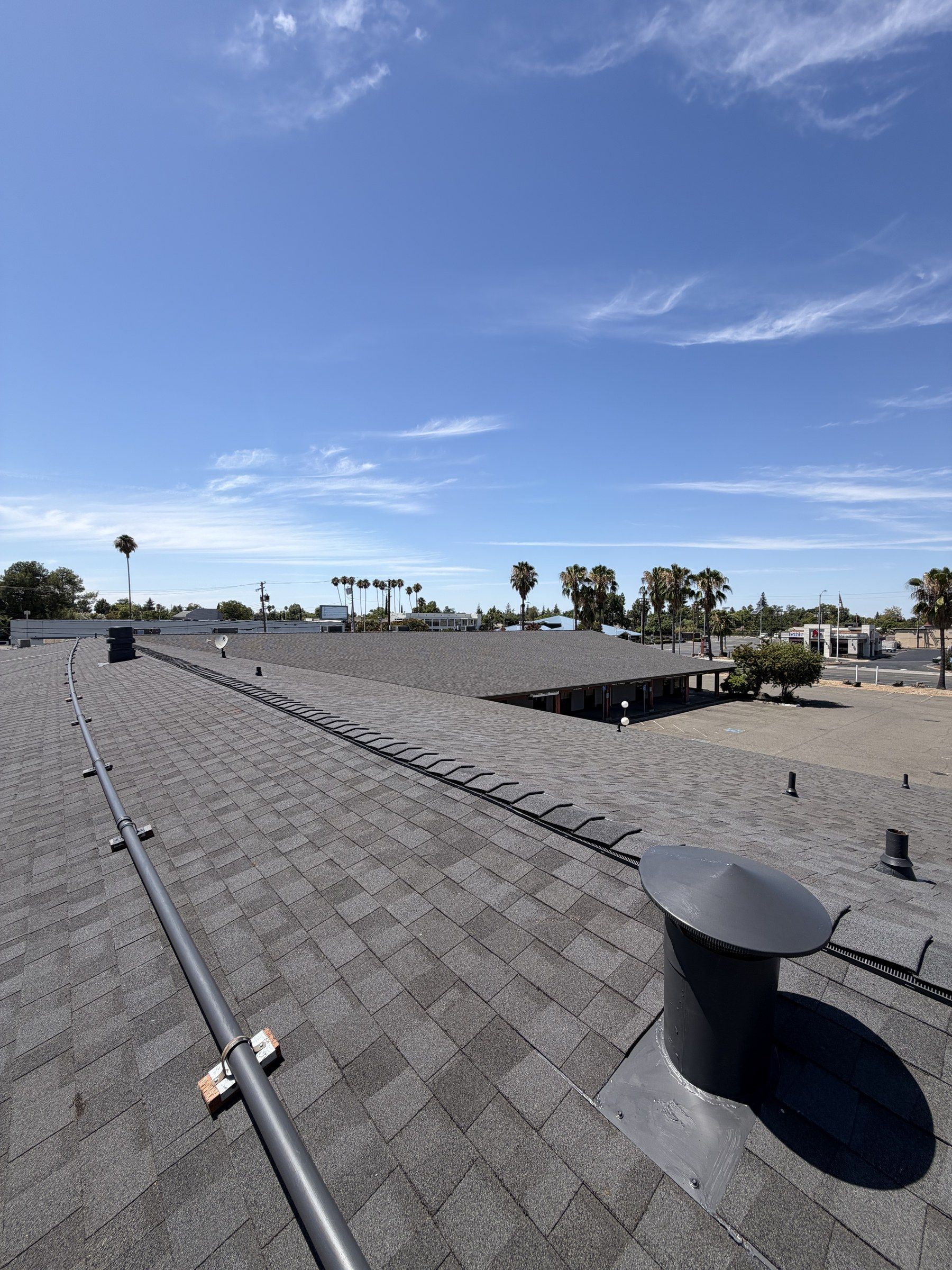 Finished shingle roof with a ridge vent and new roof jacks on a Sacramento commercial building