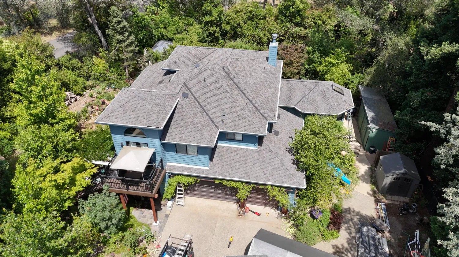 Front aerial view of the new Presidential Shake roof on a blue two-story home in Granite Bay