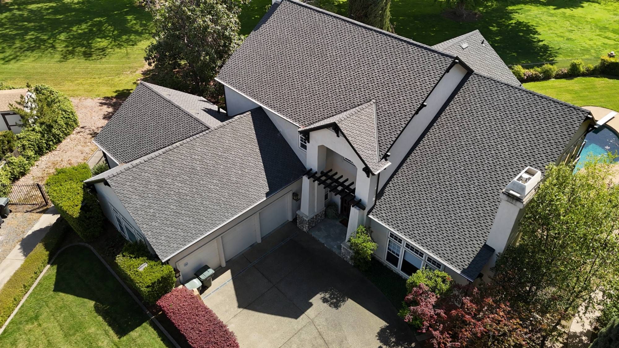 Angled aerial view of the new Presidential Shake roof and black gutters on a North Ridge Country Club home