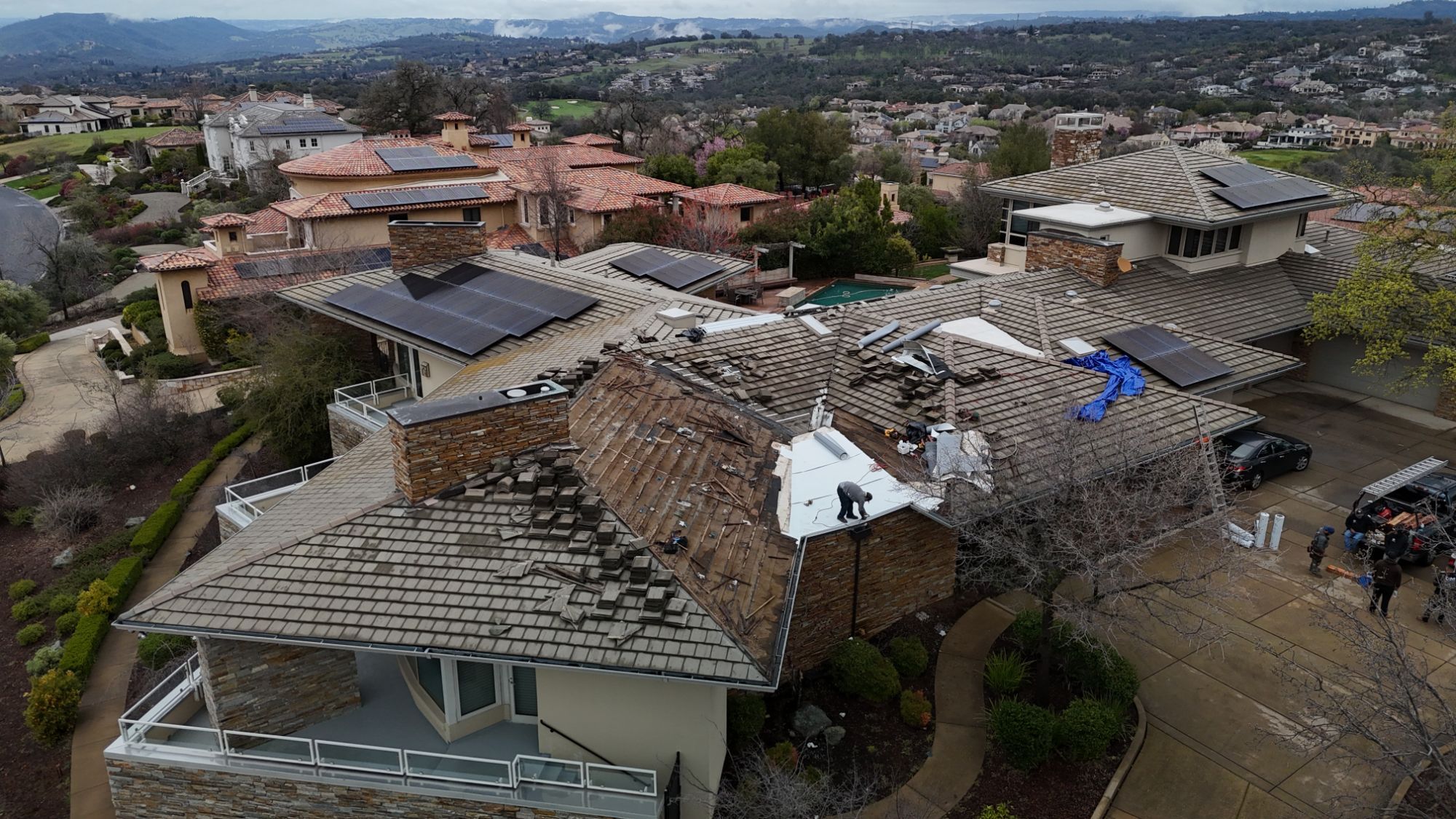 GM Roofing crew repairing a tile roof and flashing on a hillside home in the Sacramento Valley foothills