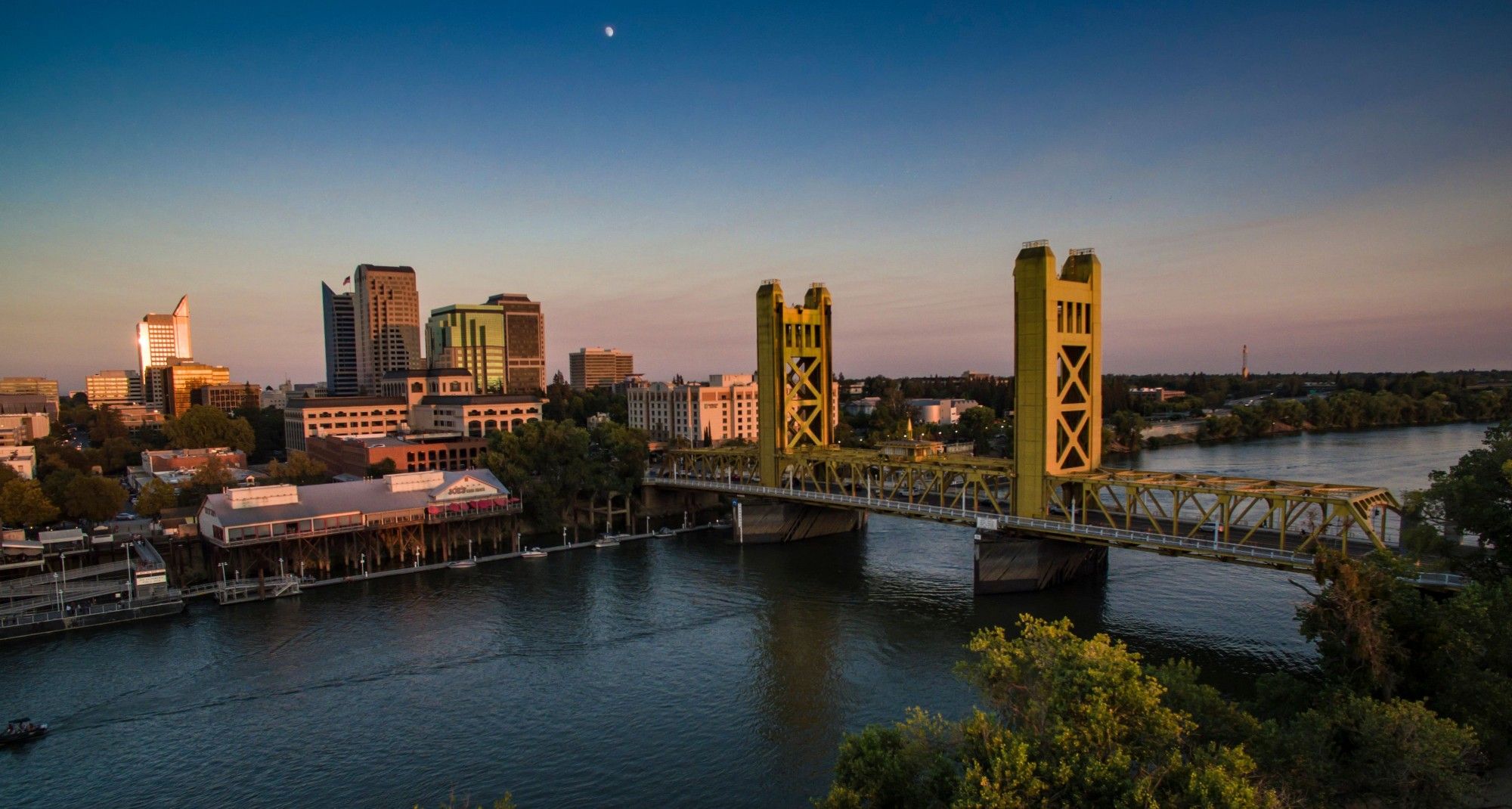 Downtown Sacramento skyline and the Tower Bridge over the Sacramento River at sunset