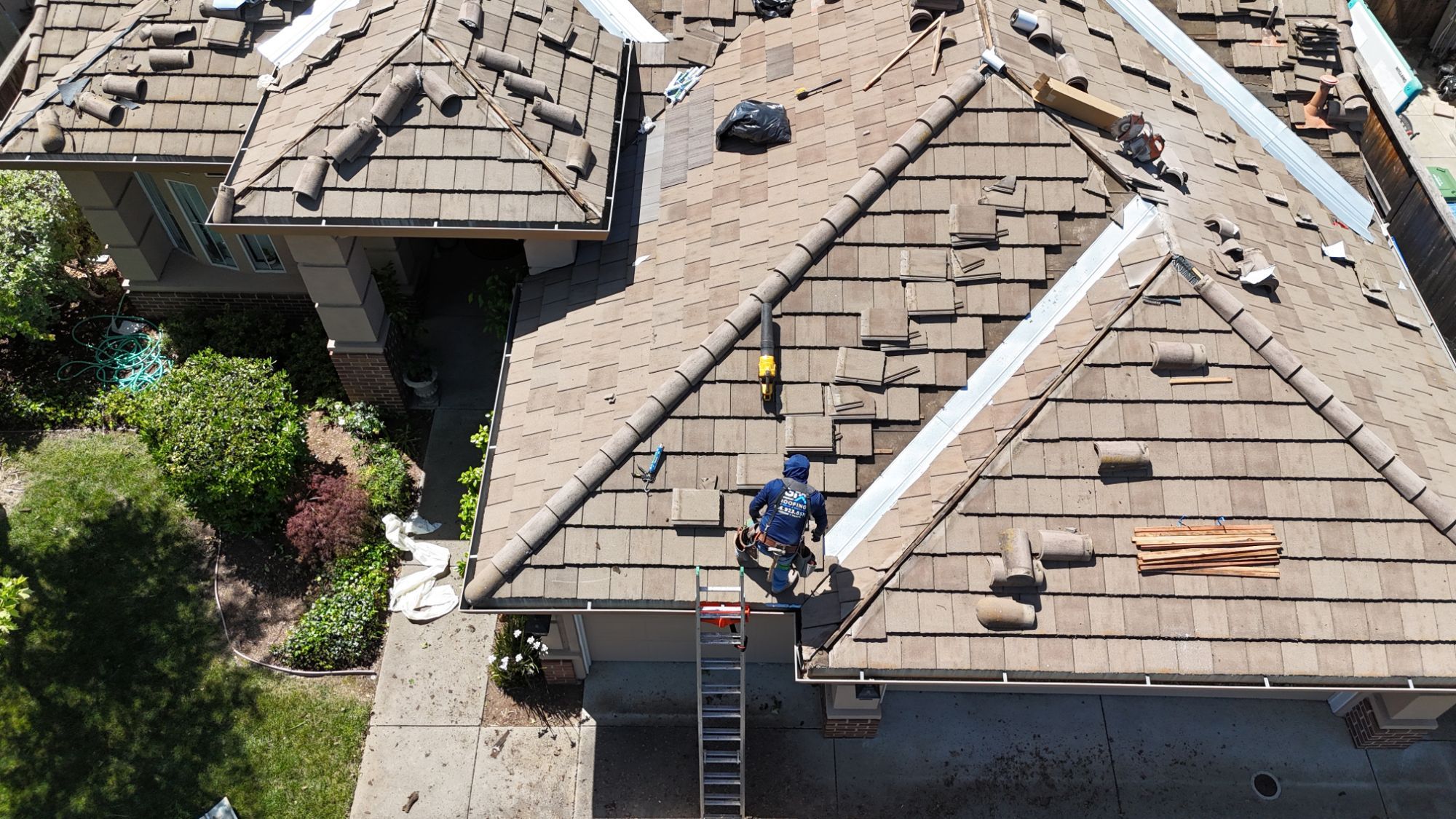 GM Roofing roofer resetting concrete tile next to new valley flashing