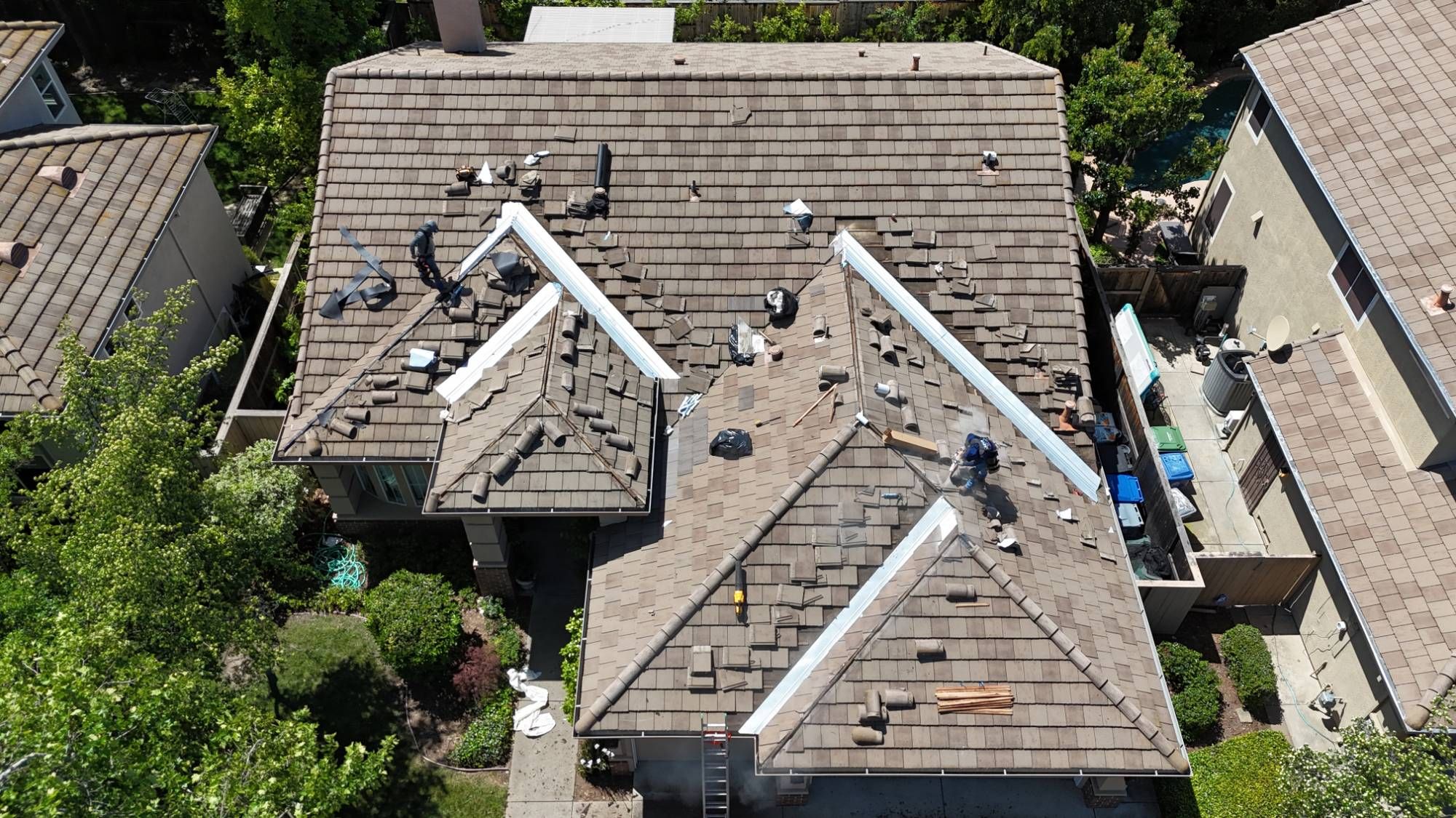 Overhead view of a Sacramento tile roof with tile lifted along the valleys and new metal flashing installed